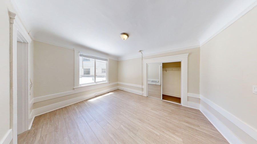 A room with a window and a door.